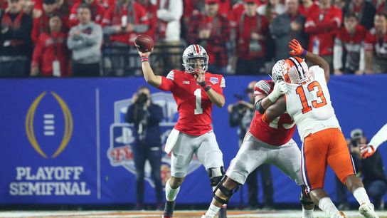 Dec 28, 2019; Glendale, AZ, USA; Ohio State Buckeyes quarterback Justin Fields (1) throws a pass against Clemson Tigers defensive tackle Tyler Davis (13) during the first quarter in the 2019 Fiesta Bowl college football playoff semifinal game at State Farm Stadium. Mandatory Credit: Mark J. Rebilas-USA TODAY Sports